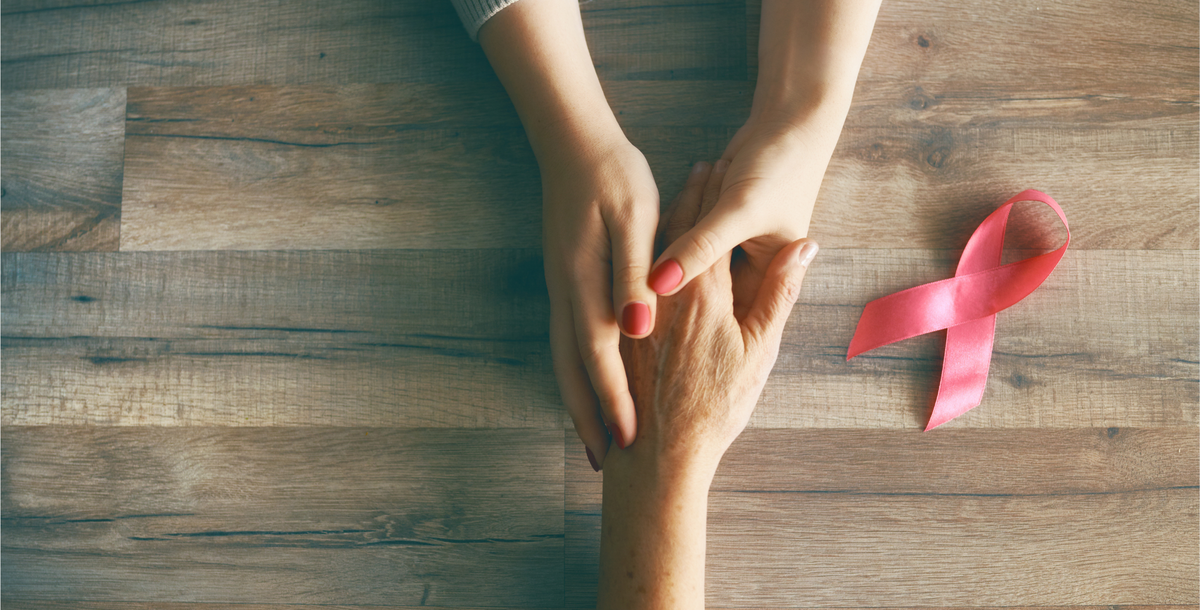 Holding hands with a pink breast cancer ribbon